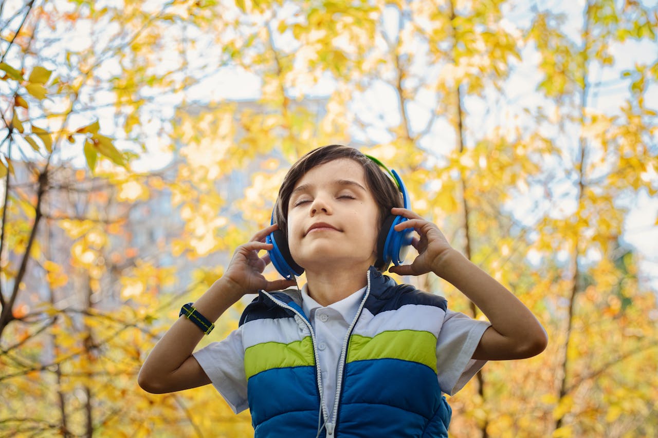 Boy enjoying listening to headphones.